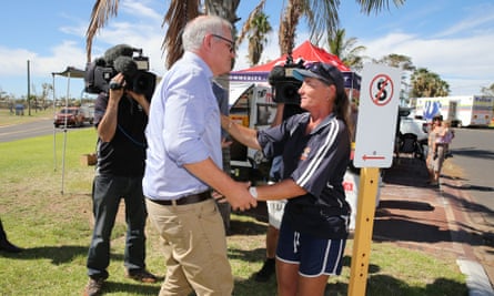 Scott Morrison meets a local resident as he visits cyclone-affected areas in the tourist town of Kalbarri