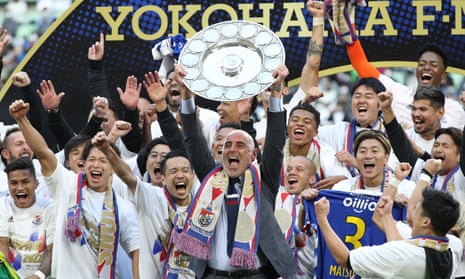 Yokohama F Marinos manager Kevin Muscat celebrates with teammates after taking Japan's professional J-League football title following a 3-1 victory over Vissel Kobe to put them at the top of the standings.