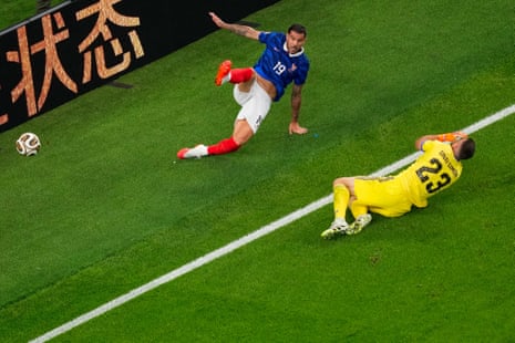 Spain’s goalkeeper Unai Simon falls after colliding with France's Theo Hernandez.