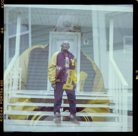 Double exposure of a man wearing a letterman jacket in front of his gray house