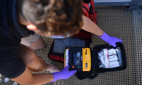A man checks a defibrillator in its case