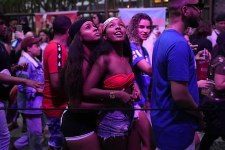 Women dance during the Gay Pride parade along Icarai Beach, in Niteroi on 7 August