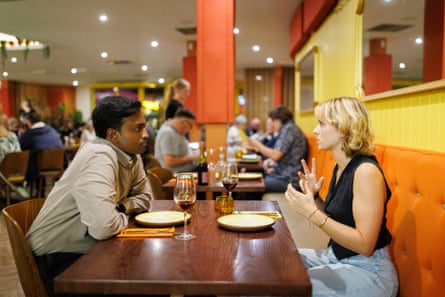 Eshwar and Georgia chat across a restaurant table