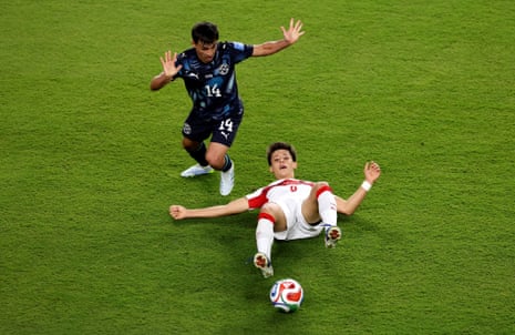 Arda Guler Turkey competes for the ball against Andres Cubas of Paraguay.