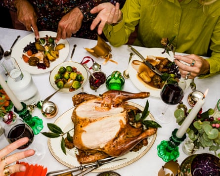 A partially eaten turkey on a Christmas dinner table