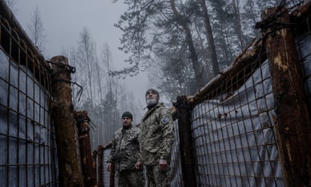 Oleksandr, right, walks through trenches that are part of a new defence line not far from Ukraine’s border with Belarus.