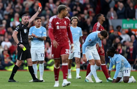 Ryan Gravenberch of Liverpool receives a red card from the referee Chris Kavanagh.