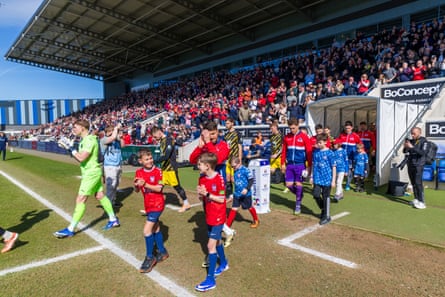 York City and Altrincham walk on to the pitch.