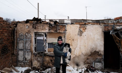 A woman in front of her destroyed home in the town of Staryi Saltiv in Kharkiv region