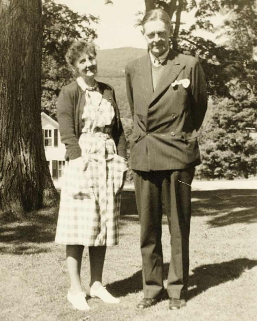 Smiling people standing together in a large garden
