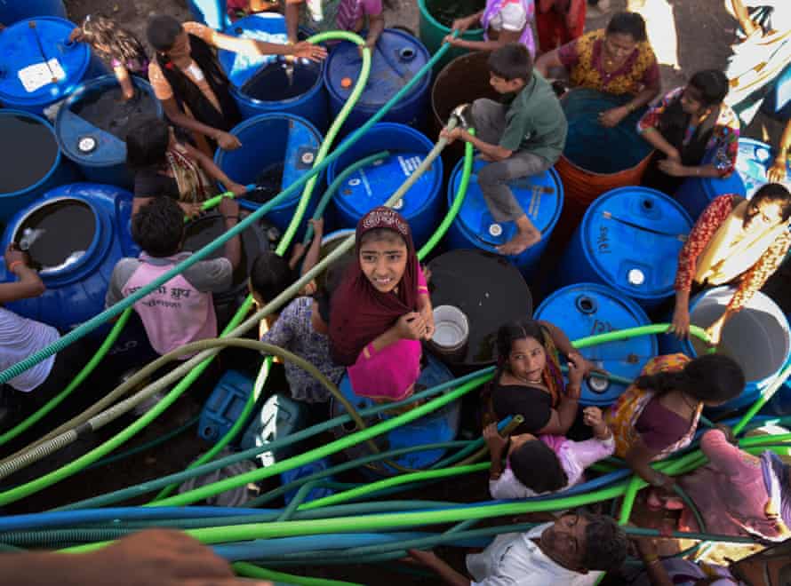 Villagers gather around a tanker for supplies of potable water in Latur, India