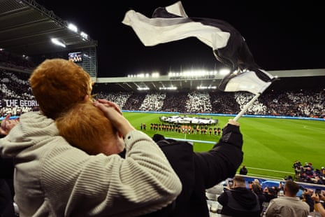 Fans of Newcastle United look on as they wave a flag prior to the UEFA Champions League match between Newcastle United FC and Paris Saint-Germain at St. James Park.