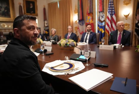 Ukrainian President Volodymyr Zelenskyy (L) looks on during a meeting with Donald Trump and members of his Cabinet at the White House on 17 October 2025.