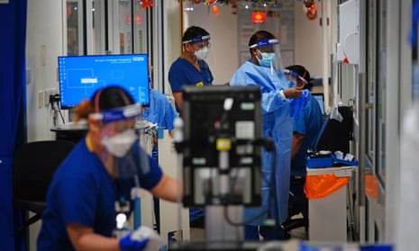 Medical staff wearing PPE on a ward for Covid patients at King's College Hospital, London, in December 2021.