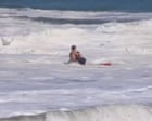 Teen lifeguard struggles to save boy from massive waves in California - video
