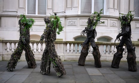 Stilt-walkers dressed as tree-spirit "Ents" outside the Department of Energy Security and Net Zero, as they call for the closure of the Drax power station, on December 02, 2024 in London, England.