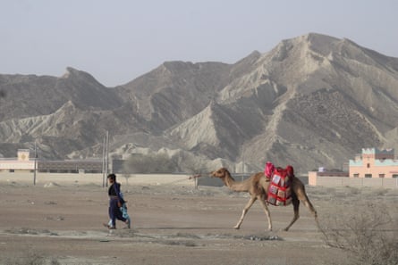 Camel rider Abdul Qadeer leads Chirag, laden with books, to the town of Abdul Rahim Bazar, in Gwadar.