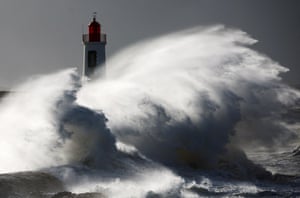 Waves crash against a lighthouse