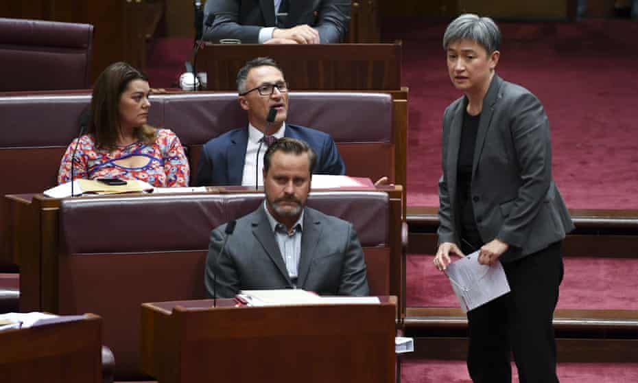 The leader of the Australian Greens, Senator Richard Di Natale, centre, speaks to the leader of the opposition in the Senate, Penny Wong.