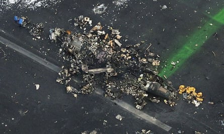 An aerial view shows burnt Japan Coast Guard aircraft after a collision with Japan Airlines’ (JAL) Airbus A350 plane at Haneda International Airport in Tokyo