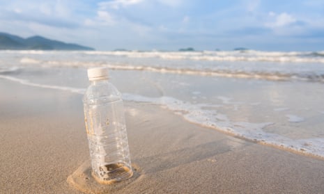 An empty plastic bottle on a beach
