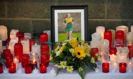 Floral tributes surround a photograph of Ashling Murphy at Kilcormac Killoughey Gaelic Athletic Association club.