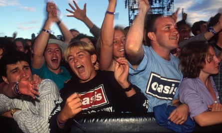 Excited-looking fans, some in Oasis T-shirts.