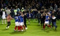 Portsmouth's players celebrate on the pitch after they secured promotion as League One champions by beating Barnsley at Fratton Park