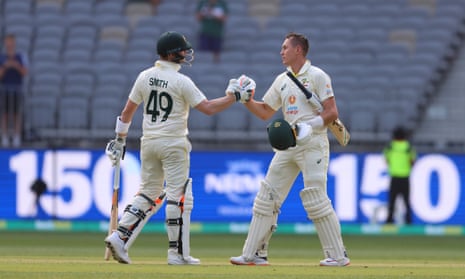 Marnus Labuschagne of Australia, right, celebrates reaching 150 during day one of the first Test match against West Indies in Perth.