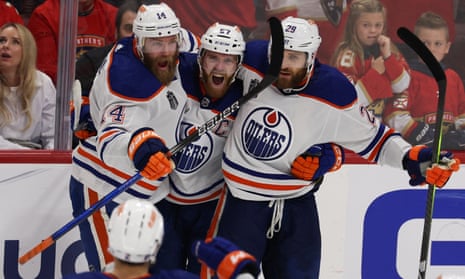 Connor McDavid (97) of the Edmonton Oilers celebrates with teammates after scoring his first goal against the Florida Panthers on Tuesday night