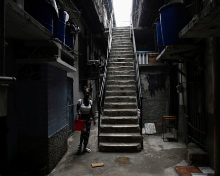 A woman walks in the courtyard of a building in Havana, as Cubans from all walks of life hunker into survival mode amid prolonged blackouts and soaring prices.