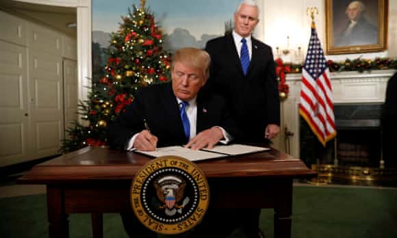 Donald Trump signs an executive order on Jerusalem as Mike Pence looks on