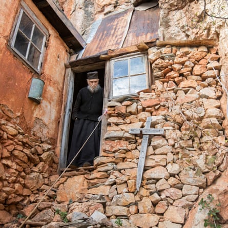 Father Arsenios by the entrance of his cell. He has not left there for 64 years as he is too old and frail now to climbs the cliffs which surround his cell.