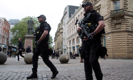Armed police patrol the streets Of Manchester.