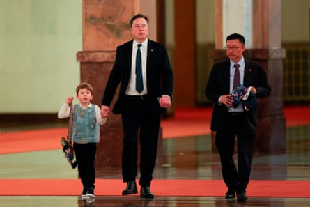 two men in suits walk alongside a boy