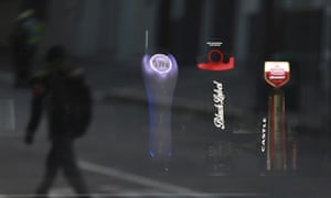 Beer taps of South African Brewery brands are seen through the window of a bar as a passing man’s reflection is caught in the window in Cape Town, South Africa, Thursday, 7 May 2020.