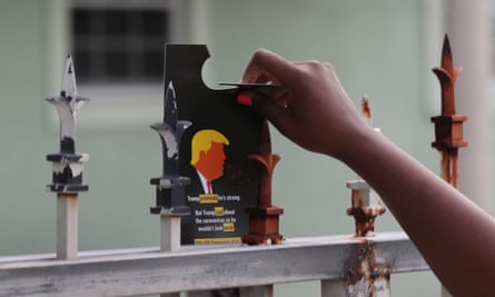 A campaign flyer encouraging people to vote for Joe Biden is placed on a fence in Miami Gardens, Florida, in a canvassing effort organized by Unite Here in October 2020.