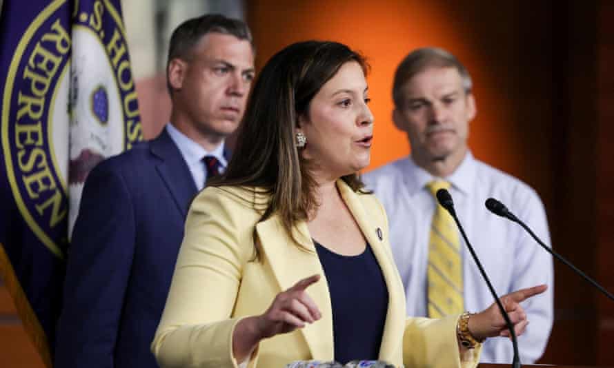 Elise Stefanik at microphone as other lawmakers look on.