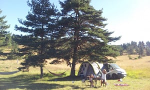 Car and tent under trees, Domaines de Pradines, France.