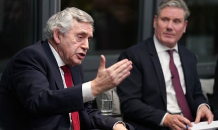 The two men seated, with Brown gesticulating