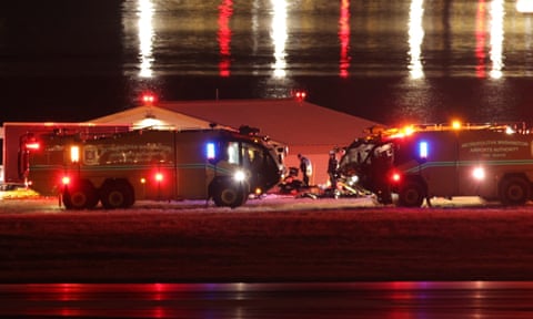 Emergency personnel work near the site of the crash.