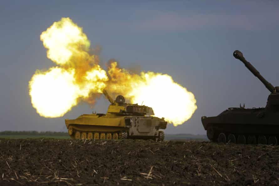 Ukrainian troops fire with a self-propelled howitzer in the Kharkiv region.
