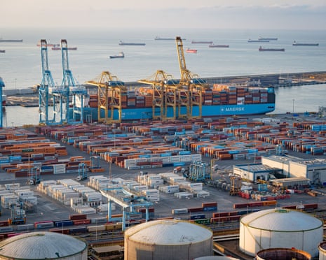Shipping containers and cargo ships seen in the port of Barcelona one of the biggest sea ports of Europe. Global trade faces uncertainty amidst potential tariffs imposed by Trump which could affect the trade relationship between the European Union and the US.