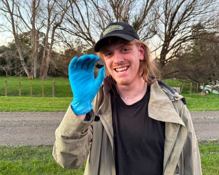 Man with blue glove holds a meteorite