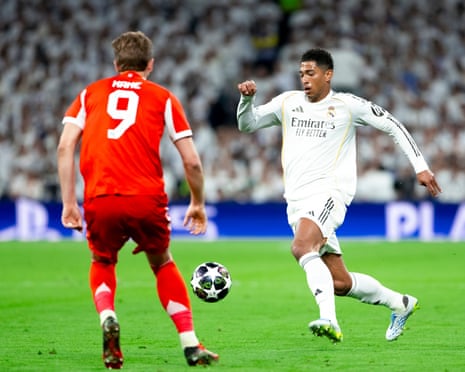 Jude Bellingham (right) gets to the ball before Harry Kane in the first leg.