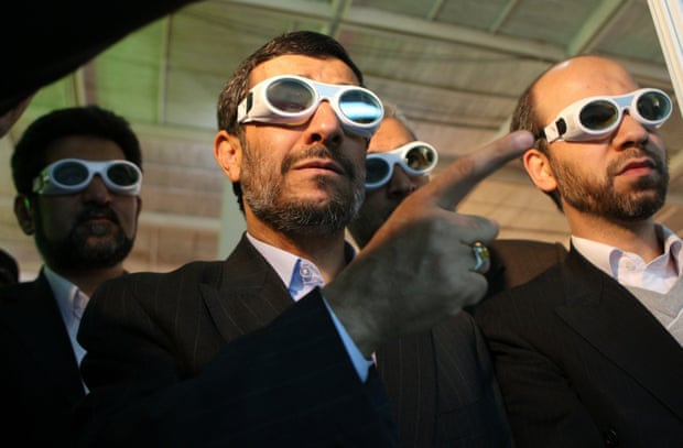 Iranian President Mahmoud Ahmadinejad tours an exhibition on laser technology in Tehran in 2010.