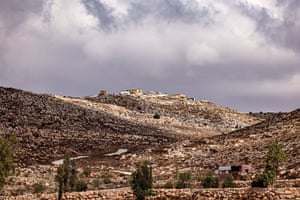 A rural setting with an Israeli settler outpost in the distance