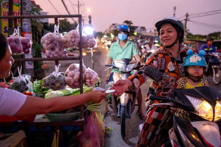 Xuan and her granddaughter, Boi Boi, ride to a market in Ho Chi Minh City to buy food for dinner.