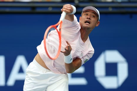 Yibing Wu of China serves against Carlos Alcaraz of Spain.