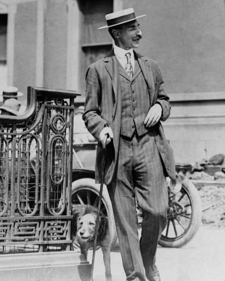 John Jacob Astor, wearing a three-piece suit, walking his dog